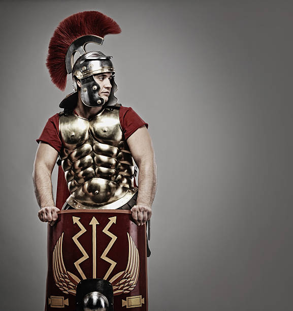 An ancient Roman soldier on a gray background stock photo