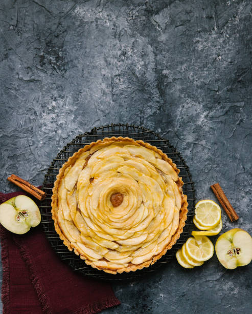 An apple pie with a lemon swirl and cinnamon stick stock photo
