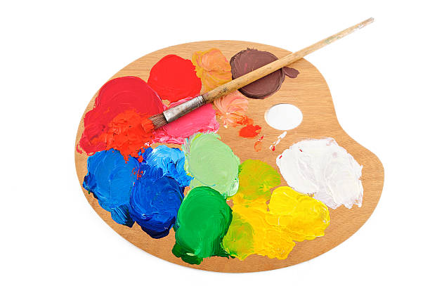 An artist palette with paint and paint brush stock photo