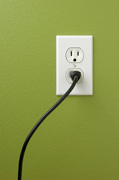 An electrical outlet with a plug inserted stock photo