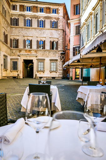 An elegant Italian restaurant in a little square near Campo de Fiori in downtown Rome. The Campo de Fiori quarter is one of the most iconic district of the eternal city, for the presence of monuments and ancient churches, but also for small squares and alleys where it is easy to find typical restaurants, pubs and little stores. Image in High Definition Format.