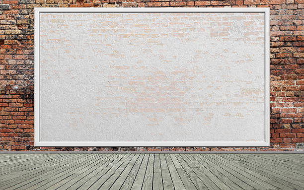 An empty billboard situated on a worn red brick wall Street scene with Red brick wall and empty billboard billboard posting stock pictures, royalty-free photos & images