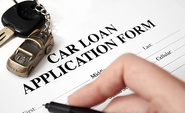 An empty car loan form with car key and a pen  Fill in the car loan application car loan stock pictures, royalty-free photos & images