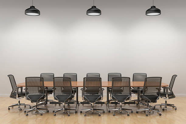 An empty meeting room and conference table An empty meeting room and conference table with big white blank wall. conference table stock pictures, royalty-free photos & images