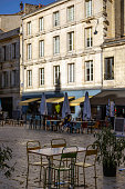 istock An empty outdoor area of a traditional french restaurant or cafe in a historic downtown. Tables and chairs without visitors.  Business in HoReCa. 1410764306