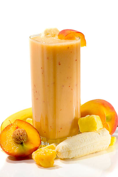 An exotic smoothie with apricots, mangos, and bananas Peach, Mango, &amp; Banana Smoothie peach smoothie stock pictures, royalty-free photos & images