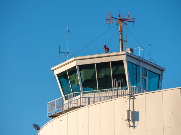 An exterior of an old and abandoned air traffic control tower from the 1930s'. VHF radio antennas on top of the roof. stock photo