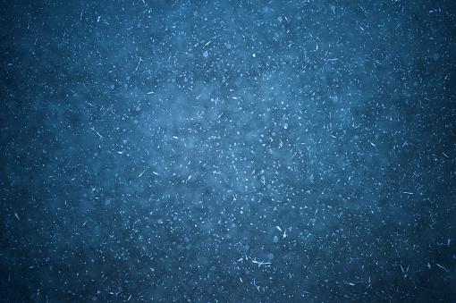 An icy dark background with white patches of frost and frozen round bubbles.