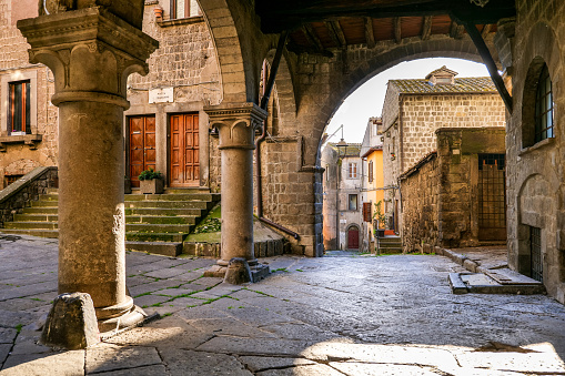 Viterbo, Italy, February 11 -- An evocative and ancient portico in the medieval quarter of San Pellegrino in the historic center of Viterbo, the capital of the ancient Etruscan region. This charming neighborhood stands on the route of the ancient Via Francigena which in medieval times connected the regions of France to Rome up to the commercial ports of Puglia to reach the Holy Land. Image in High Definition format.