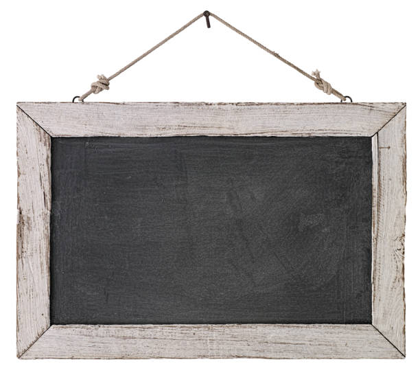 an old white wooden framed blackboard hanging from a rusty nail, isolated on white, clipping path included. - wooden sign board against white imagens e fotografias de stock