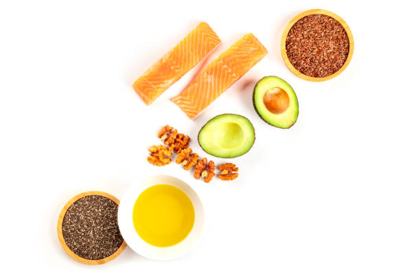 An overhead photo of healthy omega-3 diet food ingredients. Raw salmon, avocado, nuts, chia and flax seeds, shot from the top on a white background with a place for text An overhead photo of healthy omega-3 diet food ingredients. Raw salmon, avocado, nuts, chia and flax seeds, shot from the top on a white background with a place for text fat nutrient stock pictures, royalty-free photos & images