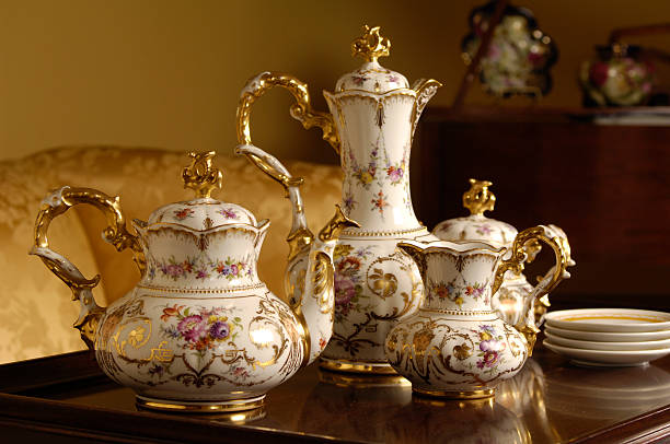 An table with an antique tea and coffee set on top stock photo