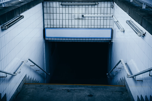an empty underpass with stairs at a train station