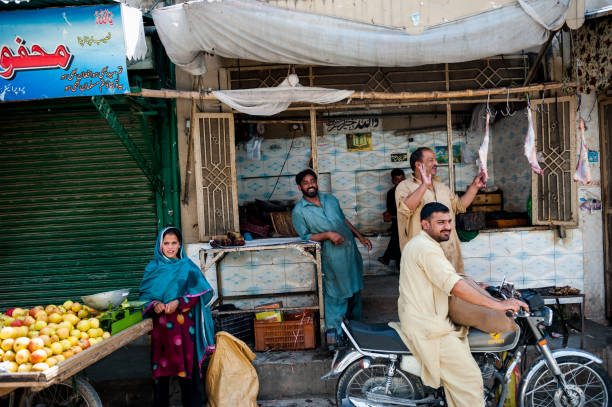 An unidentified People in the market of the Taxila TAXILA, PAKISTAN - APRIL 20: An unidentified People in the market of the Taxila, April 20, 2015 in Taxila, Taxila is an important archaeological site of the ancient Indian subcontinent punjabi dress stock pictures, royalty-free photos & images