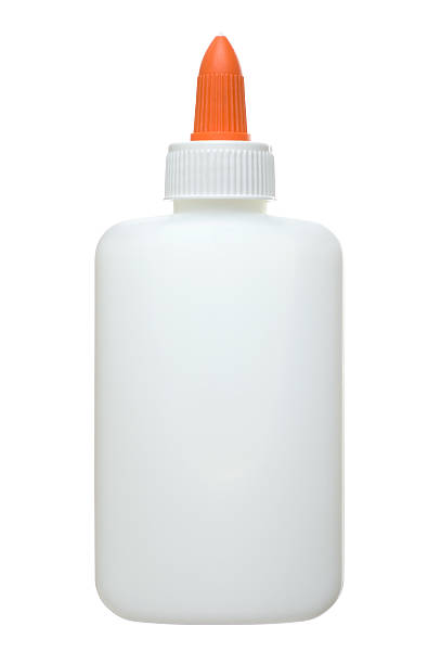 An unlabelled white and orange glue bottle stock photo