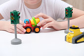 istock An unrecognizable boy playing toy cars and traffic lights, learning traffic rules in playful way 1345224807