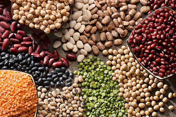 An up close picture of organic legumes Piles of a variety of healthy organic legumes. lentil stock pictures, royalty-free photos & images