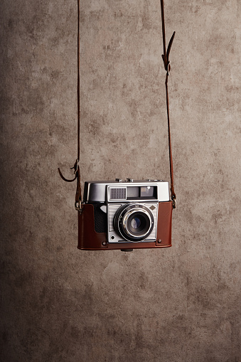 Analog vintage 35mm  film camera hanging on its strap