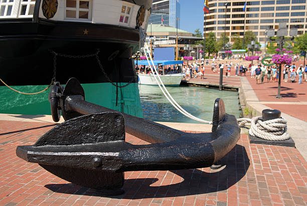 Anchored Ship Historic ship Constellation anchored at Inner Harbor of Baltimore inner harbor baltimore stock pictures, royalty-free photos & images