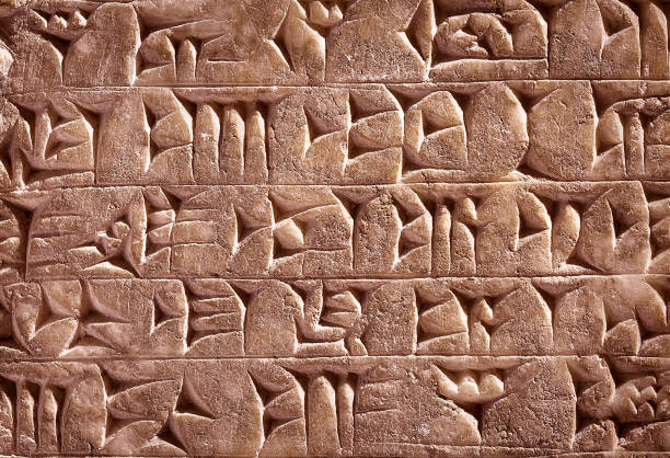 Ancient Assyrian and Sumerian cuneiform from Mesopotamia Ancient cuneiform from Babylon in Mesopotamia. Assyrian and Sumerian writing carved on clay or stone. Remains of the culture of ancient civilization in the Middle East. Old cuneiform script close-up. sumerian civilization stock pictures, royalty-free photos & images