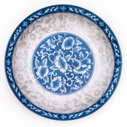 Ancient blue and white porcelain plate, isolated on white.