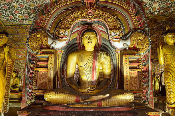 Ancient Buddha Statues in Dambulla Cave Temple, Sri Lanka The Rock Temple of Dambulla, called Jumbukola Vihara (also known as the Golden Temple or Dambulla Cave Temple) in the (Mahavamsa)-the principal Pali Chronicle of Sri Lanka, is situated about forty seven miles north west of Kandy, the last capital of the Sinhalese kings, on the main road to Anuradhupura. dambulla stock pictures, royalty-free photos & images