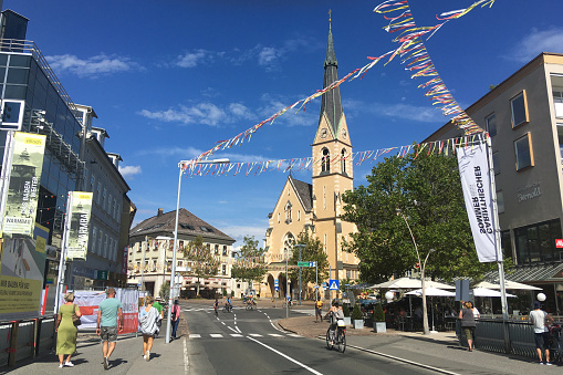 Walking towards One of the Oldest and Beautiful Churches in Villach during an Hot Summer Afternoon. A beautiful day for tourists in Carinthia, Austria