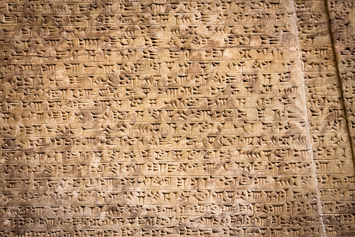 Ancient cuneiform writing script on the wall
