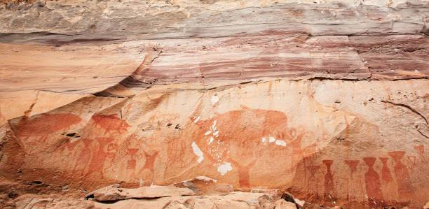 Ancient paintings on the cliff near the Mekong River. stock photo