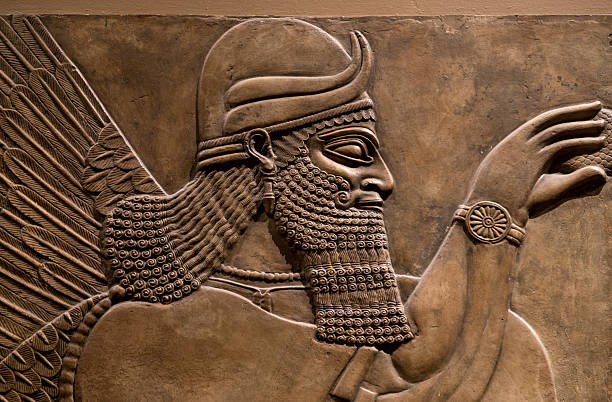 Ancient relief of an assyrian god Ancient relief of an assyrian god. mesopotamian stock pictures, royalty-free photos & images