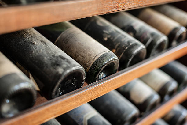 Ancient wine ancient wine bottles dusting in an underground cellar cellar stock pictures, royalty-free photos & images