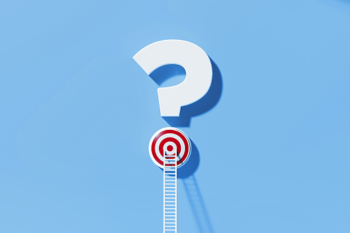 White ladder leaning on a red target which sits over a question mark symbol on blue background. Horizontal composition with copy space. Q and A concept.
