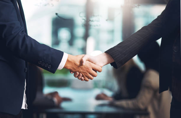 And so the deal was sealed Cropped shot of a businessman and businesswoman shaking hands in a modern office recruitment images stock pictures, royalty-free photos & images