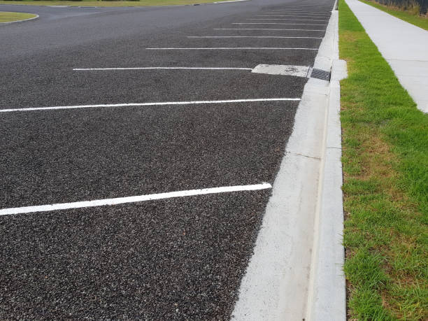Angled parking spots on road Newly marked angled parking spots on a road and footpath tar stock pictures, royalty-free photos & images