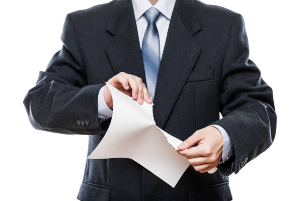 Angry businessman hand tearing paper document stock photo