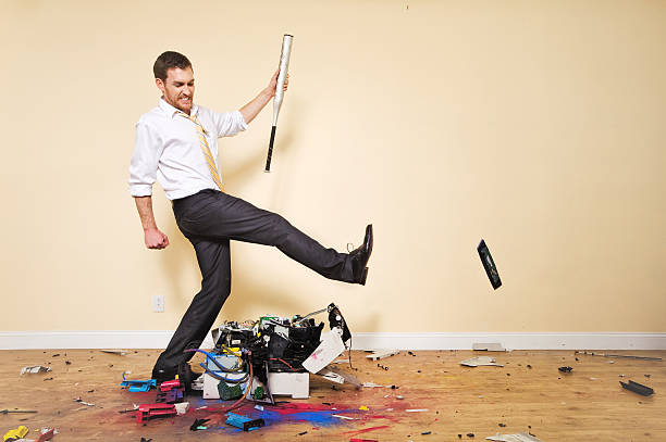 Angry Corporate Man Kicking Printer Angry corporate Man, kicking, smashing, breaking printer. xerox photocopy machine stock pictures, royalty-free photos & images