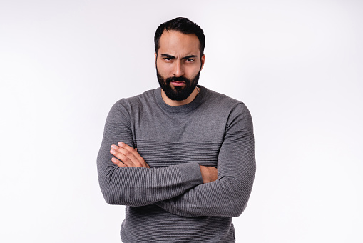 Angry handsome Arab man in casual attire isolated over white background