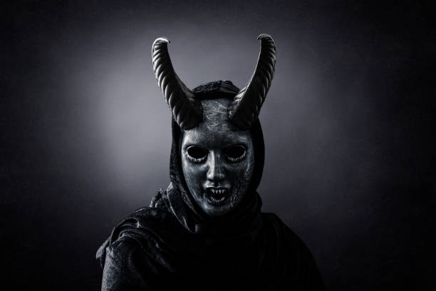 Angry horned demon in the dark stock photo