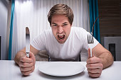 Angry Man Holding Knife And Fork