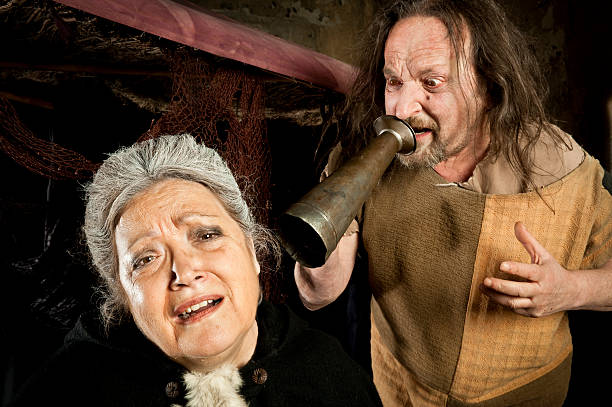 Angry man shouting an old woman stock photo