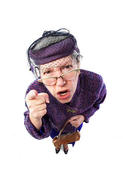 Angry old lady with eyeglasses pointing finger An old lady angrily pointing and shouting ugly old women stock pictures, royalty-free photos & images