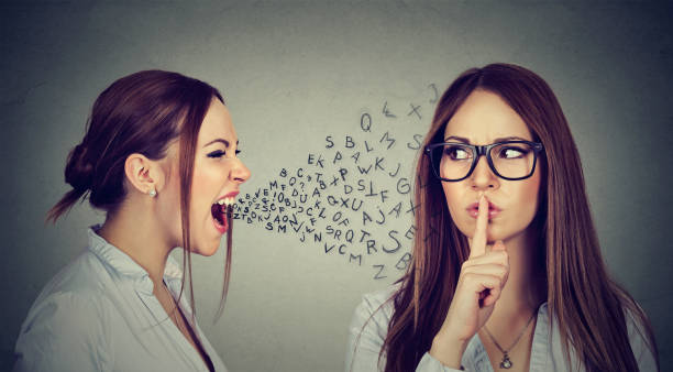 Angry woman screaming at herself with finger on lips gesture Split personality. Angry young woman screaming at herself with quiet finger on lips gesture. Negative human emotion face expression serene people stock pictures, royalty-free photos & images