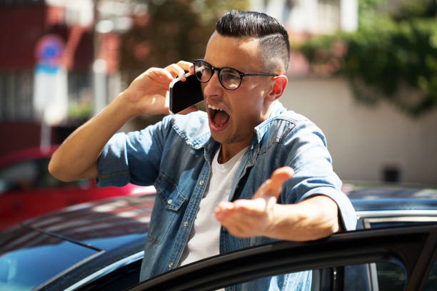 Angry young man talking on the phone stock photo