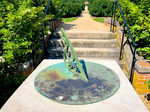 Montpelier Station, Virginia, USA - July 30, 2022: Close-up of a sundial in the Annie duPont Formal Garden located on the grounds of “James Madison’s Montpelier”, the home of Founding Father and United States President James Madison and his wife Dolly Madison.