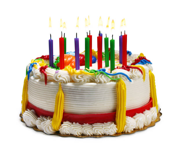 This is a colorful photograph of a vanilla cake with decorated frosting and confetti. In the middle of the cake are many colorful candles with flames coming out of it. This image could symbolize a anniversary or a birthday party