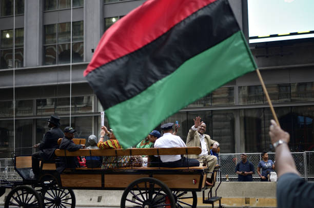 Philadelphia, PA, USA - June 23, 2018; Congressman Dwight Evans (D-PA 2nd) waves from the back of a horse-drawn carriage, during the annual Juneteenth parade in Center City Philadelphia, PA, on June 23, 2018. The Juneteenth Independence Day or Freedom Day commemorates the announcement of abolition of slavery on June 19, 1865.