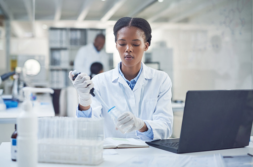 Shot of a young scientist conducting research in a laboratory