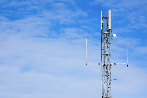 GPS antenna mast against blue sky with space for edit.Mobile internet station  in rural Britain.Connectivity UK.Mobile reception on british countryside. stock photo