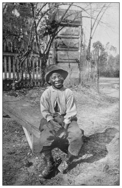 Antique black and white photo of the United States: Happy boy Antique black and white photo of the United States: Happy boy african american ethnicity photos stock illustrations