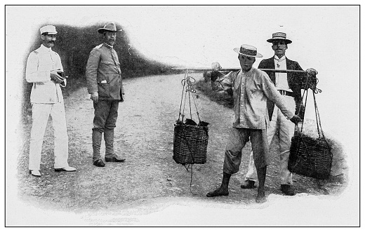 Antique black and white photograph of people from islands in the Caribbean and in the Pacific Ocean; Cuba, Hawaii, Philippines and others: Chinese farmer carrying products to market, Hawaii